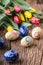 Easter. Hand made easter eggs and spring tulips on old wooden table