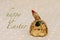 Easter handmade chicken from clay holds a green egg. happy Easter inscription