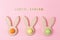Easter holiday background with colored eggs in bunny ears shaped egg cups. Happy Easter wooden letters. Flat lay.