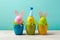 Easter holiday concept with cute handmade eggs, bunny, chicks and party hats in cup