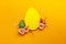 Easter holiday concept with  handmade  yellow egg, flowers on yellow background. Flat lay concept, top view. An Easter card with a