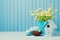 Easter holiday decoration with daisy flowers, eggs and birdhouse