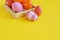 Easter holiday. Easter eggs in a tray for eggs. Eggs on a stand. Yellow background.