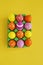 Easter holiday. Easter eggs in a tray for eggs. Eggs on a stand. Yellow background.