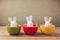 Easter holiday eggs with bunny ears on wooden table