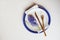 Easter holiday festive dining table with plate, golden cutlery and hyacinth flower on white background