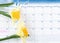 Easter holiday reminder marked on calendar with yellow daffodils