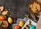 Easter holiday still life and decorations, easter eggs, cookies in the shape of rabbit and heart on dark wooden background, blank
