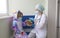 Easter in the hospital: the doctor nurse gives the girl a chocolate egg