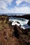 Easter Island rocky coast line under blue sky