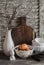 Easter kitchen still life - eggs in a bowl, a vase with dry twigs, ceramic rabbit, vintage crockery and cutting board