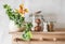 Easter kitchen still life. A wooden shelf with a flower in a ceramic pot, a jar of eggs, a ceramic rabbit on a light background.