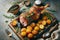 Easter leg of lamb with roasted potatoes and rosemary on wooden board