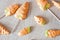 Easter meringue with candy carrots on a sticks and wooden background