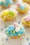 Easter mini tarts decorated with frosting and marzipan eggs in pastel colors