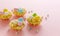 Easter mini tarts decorated with frosting and marzipan eggs in pastel colors