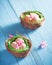 Easter nests with eggs and flowers decoration on blue background