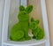 Easter one big green stuffed bunny with stuffed baby rabbit decoration on a shelf