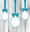 Easter paper eggs wrapping blue bows on wooden grey background