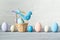 Easter pastel colored eggs and small basket with blue bird on a light wooden background