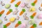 easter pattern eggs rabbit carrot Easter pattern made of colored eggs, decorative carrots and bunny rabbits on light