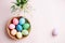 Easter picture, multi-colored eggs in a wooden plate