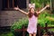 Easter portrait of happy child girl in funny bunny ears playing egg hunt outdoor