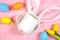 Easter product mockup with bunny ears and easter eggs on pink background flatlay