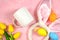 Easter product mockup with bunny ears and easter eggs on pink background flatlay