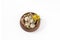 Easter quail eggs in a wooden bowl with yellow flowers on a white background. Catholic and Orthodox Easter