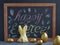 Easter.  Rabbit folded serving napkin and easter golden egg on dark blackboard background with text