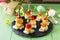 Easter recipe, festive appetizer. Canapes with pineapple, grill chicken, marinated peppers - on the festive table