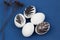 Easter rustic or scandinavian composition with white egg decorated black feather on classic blue background. Farming and healthy