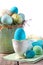 Easter scene with turquoise speckled egg in cup