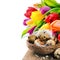 Easter setting with quail eggs and tulips