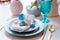 Easter and spring festive table decorated in pink and blue colours with modern golden metallic cutlery