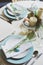 Easter and spring scandinavian festive table decorated in blue and white tones in natural rustic style