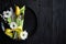 Easter spring table dishware composition with yellow tulip flower