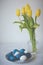 Easter still life with colored eggs and tulips