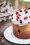 Easter sweet bread Orthodox kulich, paska, willow twigs. Easter Colorful eggs on gray wooden background. Easter Holidays