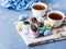 Easter sweet cup cakes treets in colorful egg shells on blue