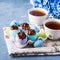 Easter sweet cup cakes treets in colorful egg shells on blue