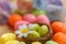 Easter sweet green eggs in a small nest. Food. White chamomile. Blurred background of purple flowers. Shallow depth of