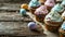 Easter sweets. Colorful cream cupcakes, candy and colored Easter eggs on old weathered board. Conceptual symbols of Easter