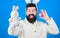 Easter symbol concept. Hipster cute bunny long ears blue background. Easter bunny. Funny bunny with beard and mustache