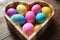 Easter symbol - heart shaped bowl full of colored eggs