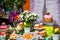 Easter table: cakes with colored glaze on stands, colored eggs and bouquets of flowers