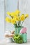 Easter table with lamb cake, bouquet of daffodils and painted eggs