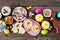Easter table scene with a selection of desserts and sweets. Top view table scene over a wood background