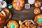 Easter table scene with a selection of fresh breads, top view frame over a dark wood background